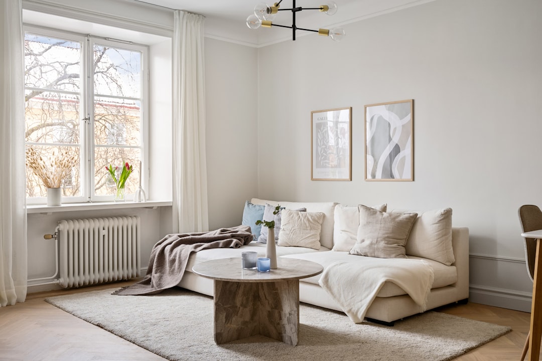 Bright small living room with layered furniture and a large window