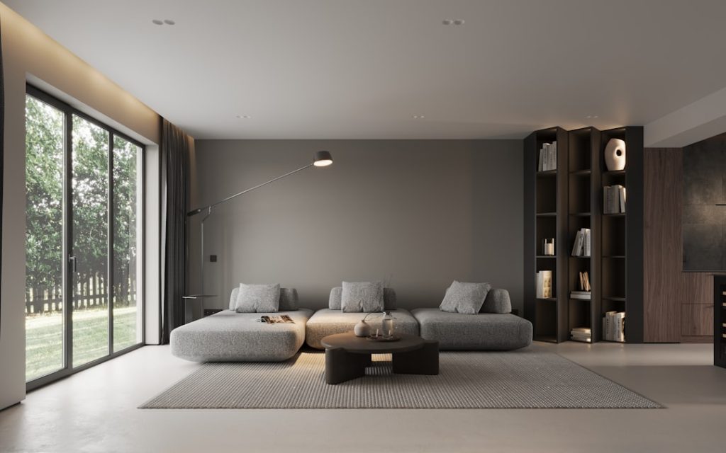 Modern neutral living room with large windows