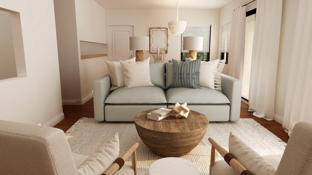 Warm neutral living room with a round wood table and white sofa