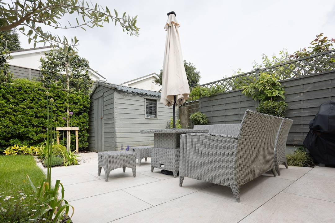 Landscaped garden patio with outdoor seating beside a modern home